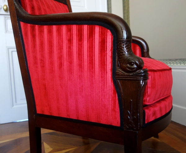 Empire mahogany bergere, dolphin-shaped armrests, early 19th century