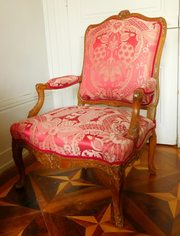 Fauteuil à la Reine richement sculpté d'époque Régence vers 1730, garniture de soie rouge