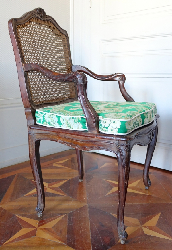 Fauteuil canné d'époque Régence Louis XV à coussin de soie