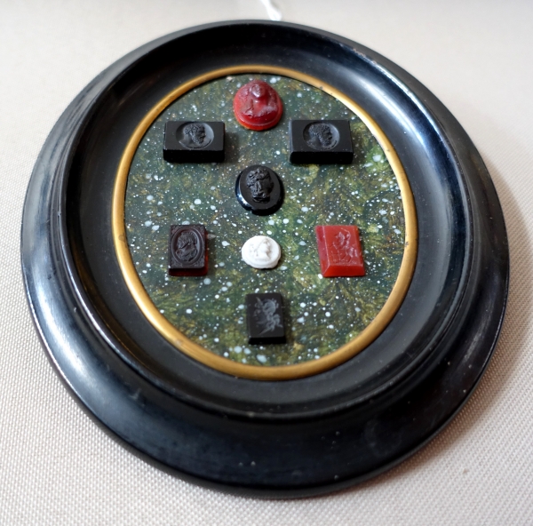 Etched semi precious stones collection on a porphyry background, 19th century