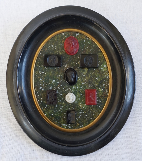 Etched semi precious stones collection on a porphyry background, 19th century