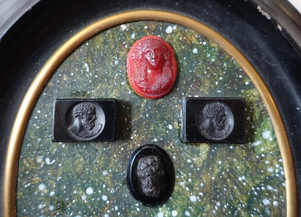Etched semi precious stones collection on a porphyry background, 19th century