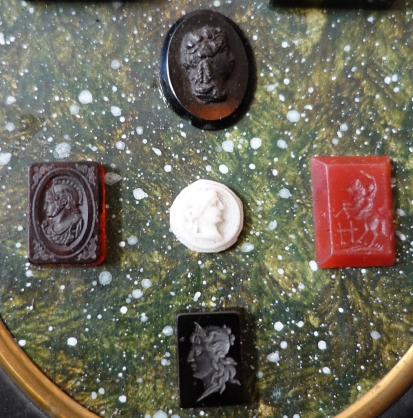 Etched semi precious stones collection on a porphyry background, 19th century