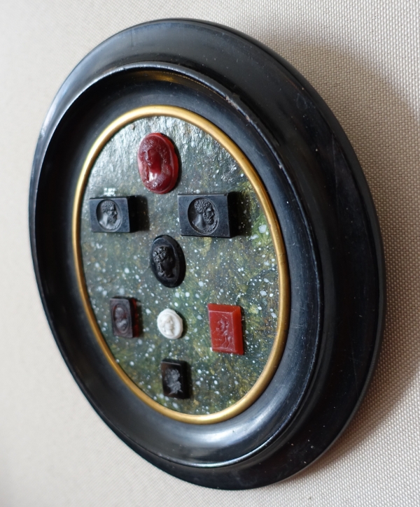 Etched semi precious stones collection on a porphyry background, 19th century