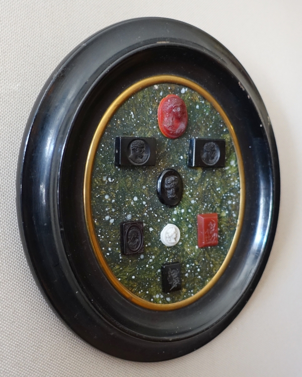 Etched semi precious stones collection on a porphyry background, 19th century