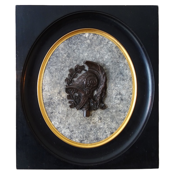 Large miniature, patinated bronze military trophee on a granite background