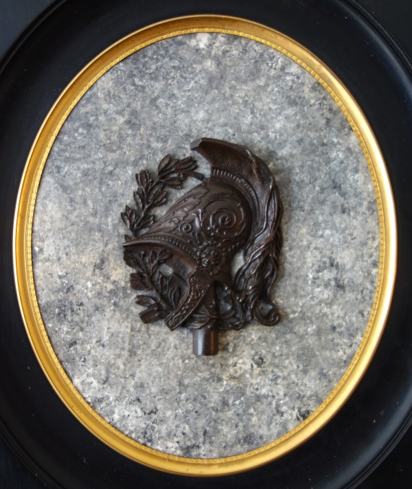 Large miniature, patinated bronze military trophee on a granite background