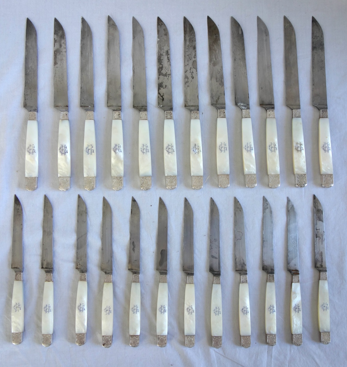 Detail — Set of 24 sterling silver and mother of pearl knives, 19th century