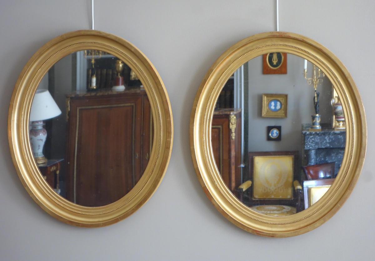 Detail — Pair of tall Louis XVI style oval mirrors, gold leaf gild wood frame, mercury glass
