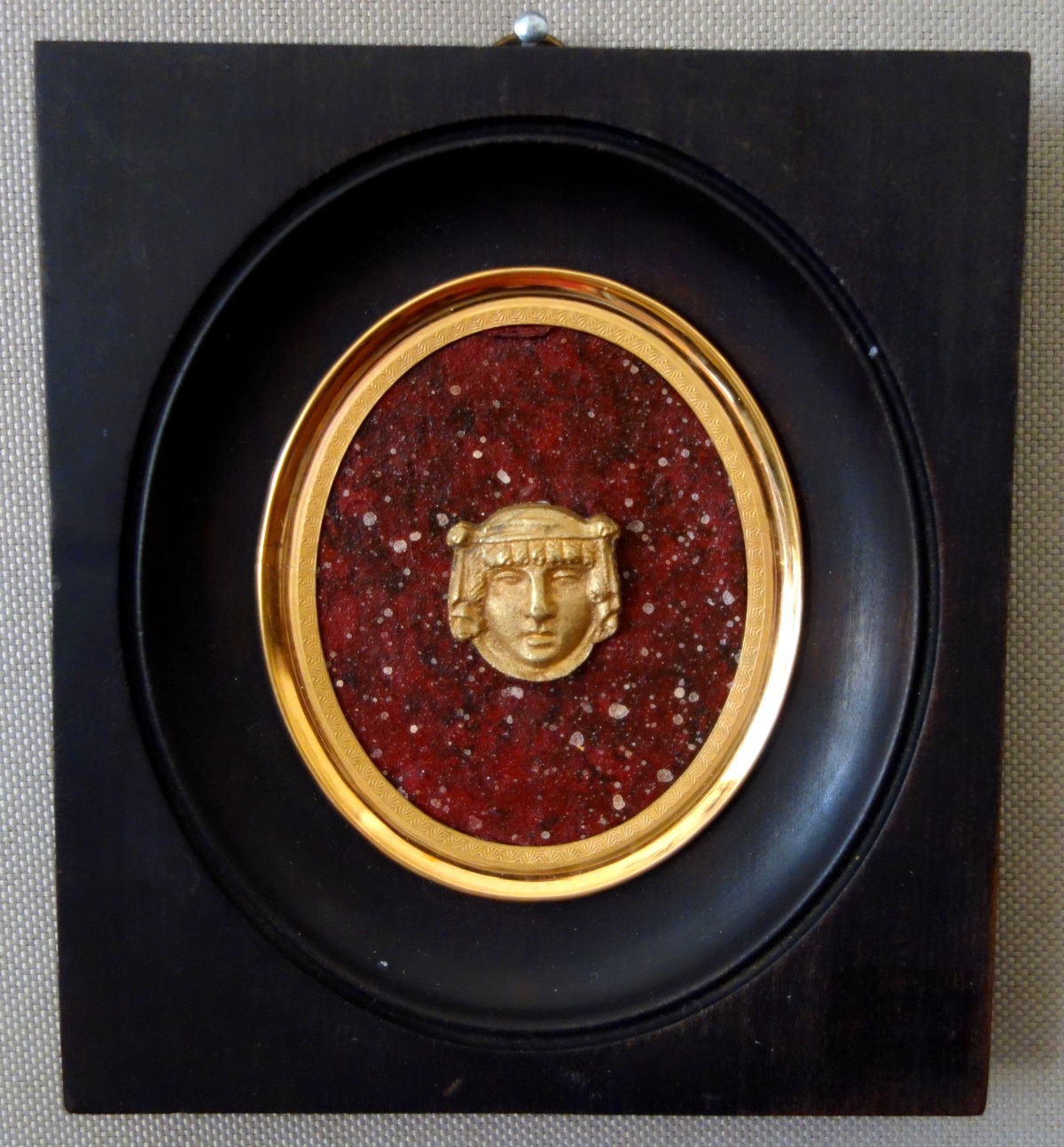 Detail — Ravrio : miniature ormolu Egyptian mask on a porphyry background, 19th century